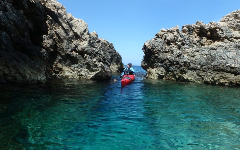 Kayaking between rocks - Island hopping sea kayak tour Croatia - Red Adventures